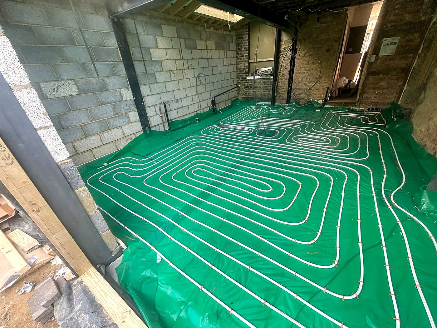 Completed underfloor heating pipe layout ready for screed, East London